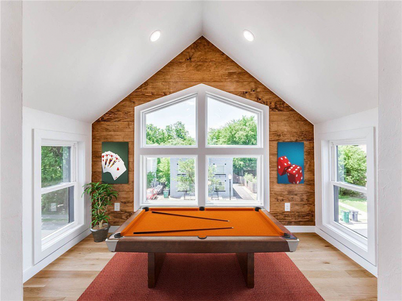 Game room or flex space with wood accent wall and pool table