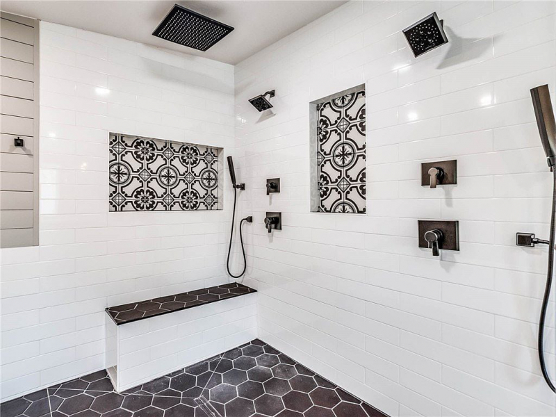 Spa shower with hexagon tiles and patterned tile accents, black hardware and rainfall shower
