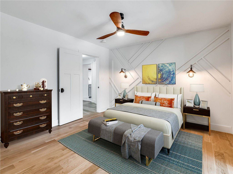 Bedroom with light wood floors and wood panel accent wall