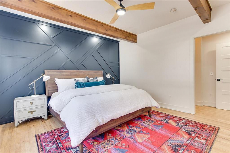 Bedroom with wood panel accent wall