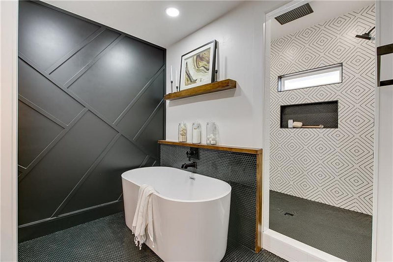Primary bathroom with dark wood panel accent wall