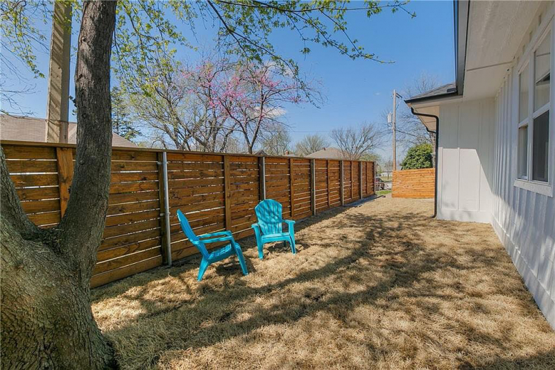 Side or backyard with adirondack chairs