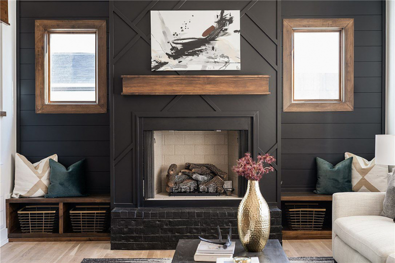Black fireplace with wood accents and wooden mantle