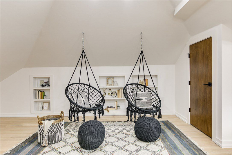 Loft with hanging chairs and built in bookcases