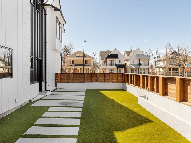 Side yard with lawn and large rectangular pavers