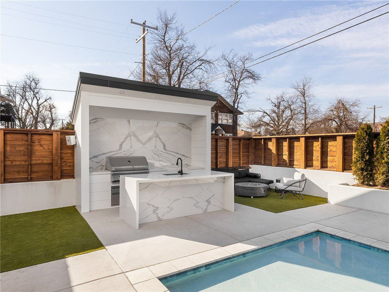 Outdoor barbecue area with white marble surfaces