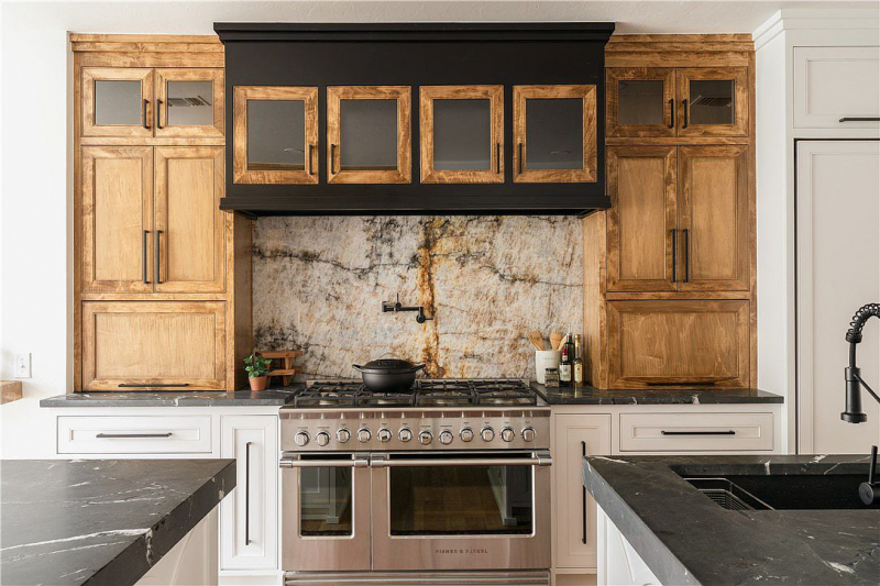 8-burner gas cooktop surrounded by wood cabinets