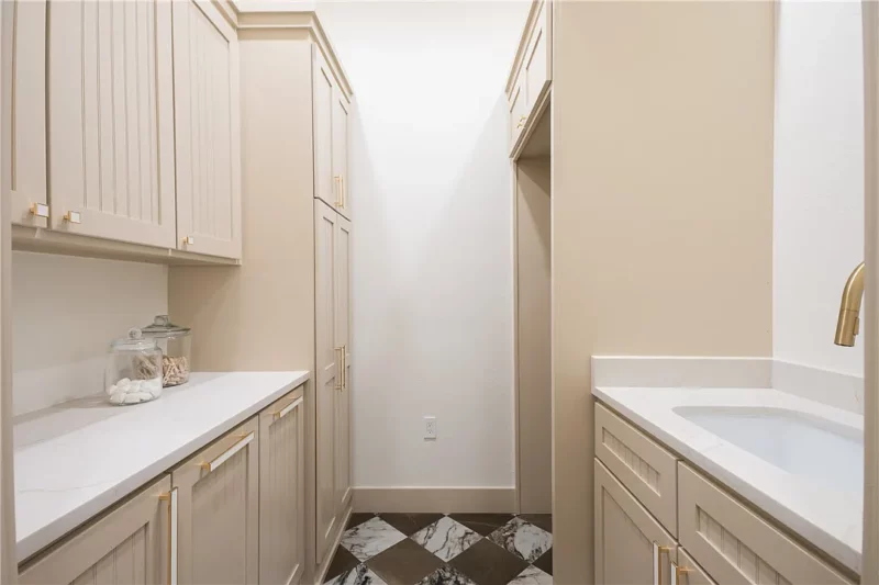 Laundry room with light tan cabinets