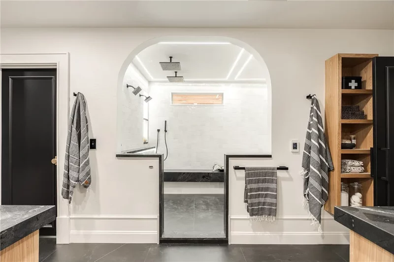 Transition into luxury bathroom with arched entrance