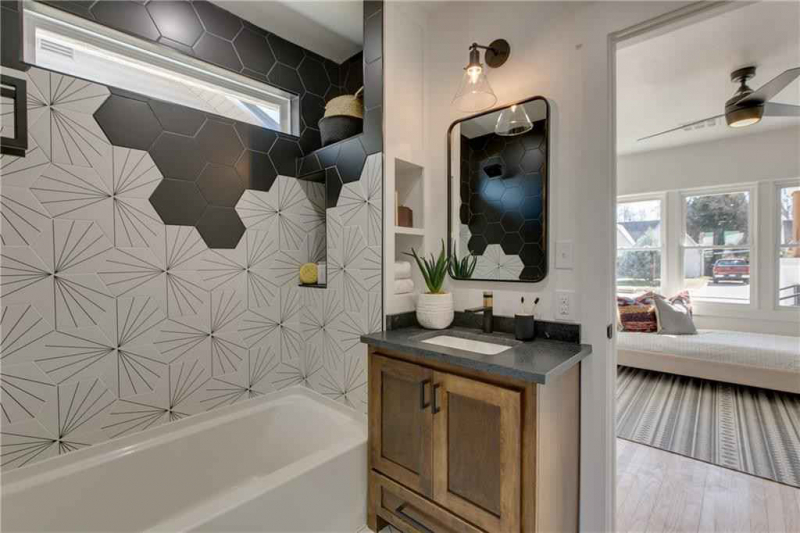 Bathroom with black and white hexagonal tile wall