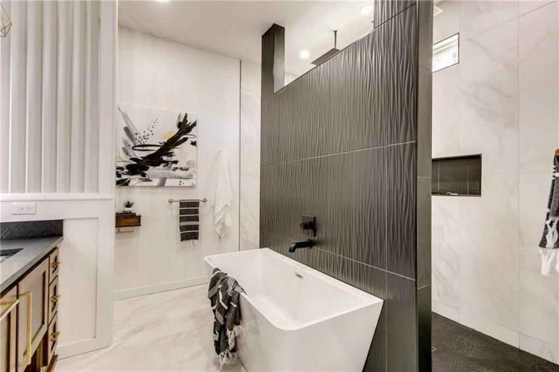 White bathtub with dark tile accent