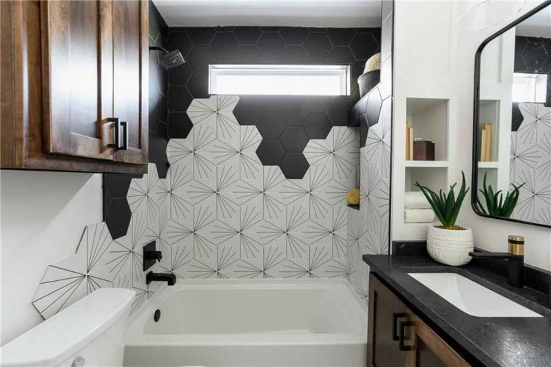 Bathroom with black and white hexagonal tile wall