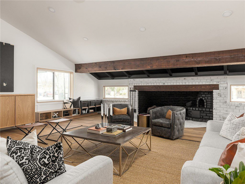 Living area with fireplace and wood beams