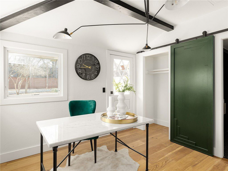 Den or office area with green sliding barn door