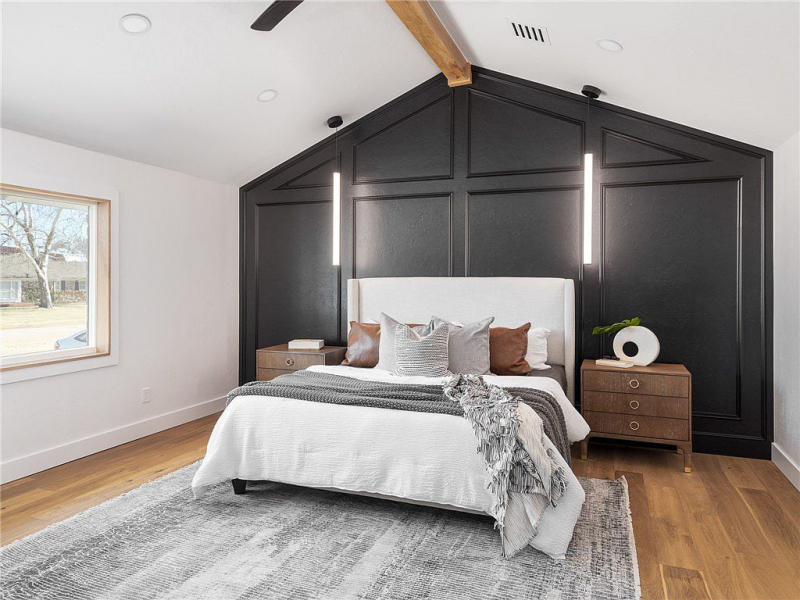 Primary bedroom with black accent wall