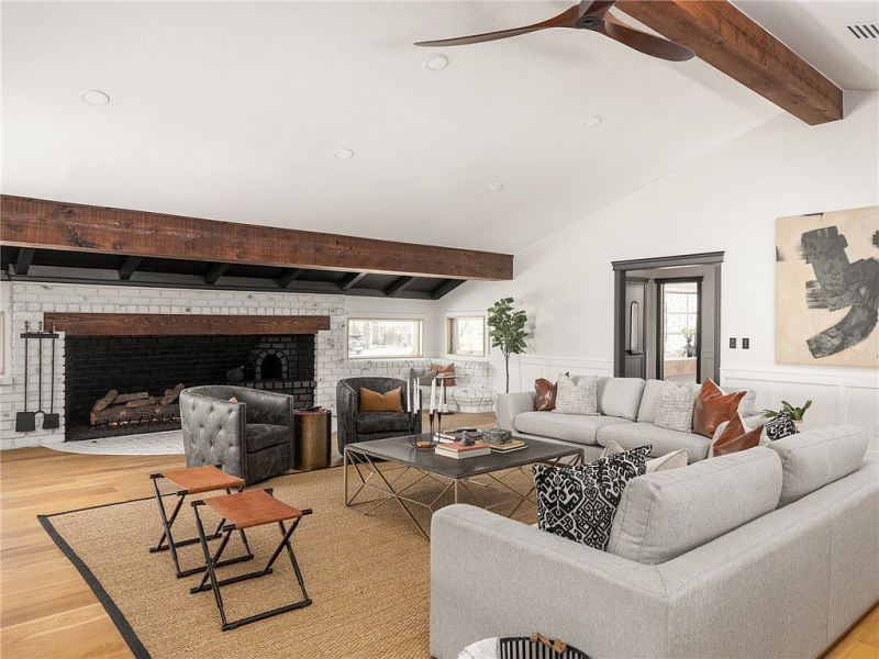 Living area with raised ceilings and wood support beams